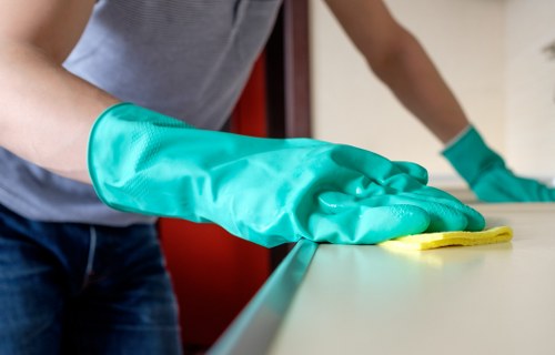 Cleaner reviewing safety procedures before continuing a task